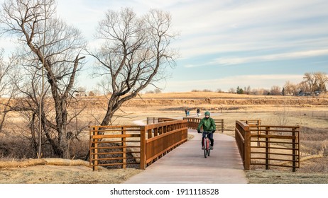 Mature Male Cyclist And Walkers On A Newly Constructed Bike Trail In A Typical Winter Or Fall Scenery Without Snow In Fort Collins In Northern Colorado