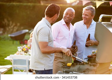 Mature Male Friends Enjoying Outdoor Summer Barbeque