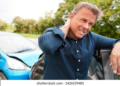 Mature Male Motorist With Whiplash Injury In Car Crash Getting Out Of Vehicle - Shutterstock ID 1426529483