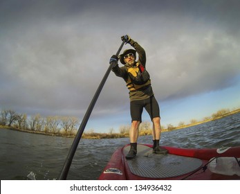 Mature Male Paddler Enjoying Workout On Stand Up Paddleboard (SUB), Calm Lake In Colorado, Early Spring