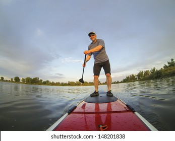 Mature Male Paddler Enjoying Workout On Stand Up Paddleboard (SUP), Calm Lake In Colorado, Summer