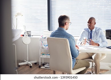 Mature Male Patient In Consultation With Doctor In Office