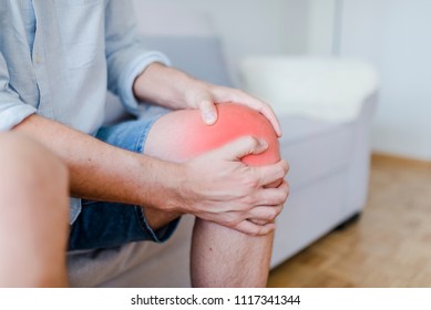 Mature Male Patient Holding Knee In Pain. Man With Knee Pain. Man With Chronic Knee Problems And Pain Man With His Hands On A Painful Leg. Leg Pain