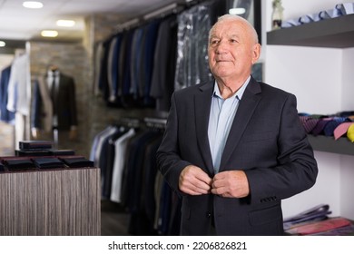 Mature Male Shopper Shows Off His Jacket At A Men's Store