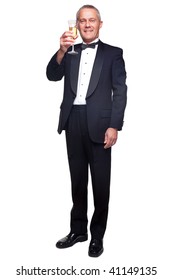 A Mature Male Wearing A Black Tuxedo And Bow Tie Raising A Glass Of Champagne, Isolated On A White Background.