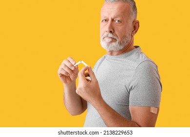 Mature Man With Applied Nicotine Patch And Broken Cigarette On Color Background. Smoking Cessation