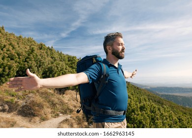 Mature man with backpack hiking in mountains in summer. - Powered by Shutterstock