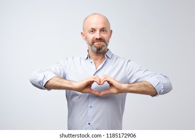 Mature Man With Beard Making Out Of The Hands Heart. Healthy Lifestyle