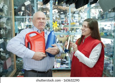 Mature Man Buys Motor Oil In Auto Parts Store