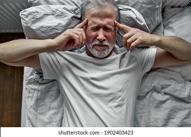 Mature Man With Closed Eyes Lying In Bed, Touching Temples Close Up, Tired Older Male Suffering From Headache Or Migraine, Feeling Unwell, Suffering From Insomnia, Lack Of Sleep