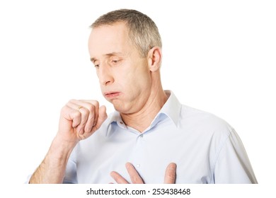 Mature man coughing because of flu.