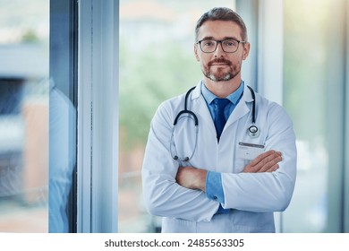 Mature man, doctor and arms crossed for portrait in hospital, medical support and cardiologist. Male person, medicine and physician at hospital for consultation service, medicare and proud medicine - Powered by Shutterstock