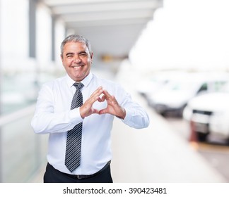 Mature Man Doing A Heart Symbol