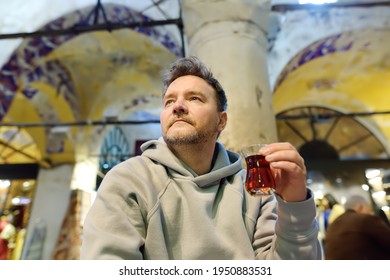 Mature Man Drink Turkish Tea Sitting In Small Cafe In The Grand Bazaar In Istanbul, Turkey. Dishes Of Traditional Turkish Kitchen.