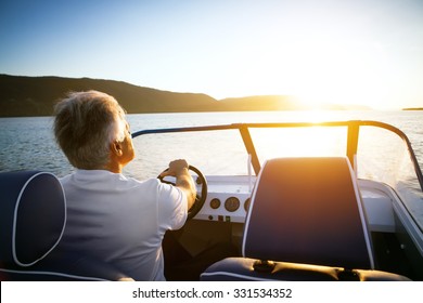 mature man driving speedboat