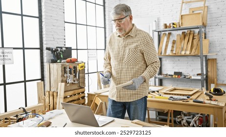 A mature man examines wood in a bright carpentry workshop, surrounded by tools and safety gear. - Powered by Shutterstock