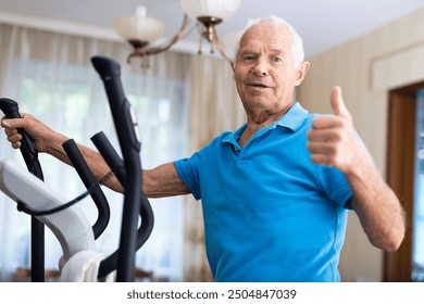 Mature man exercising on an elliptical machine - Powered by Shutterstock