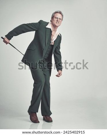 Mature, man and fashion with whip in studio with suit on grey background and vintage look. Tuxedo, elegance and retro with riding crop and formal in expensive clothes, classy and fashionable Stock photo © 