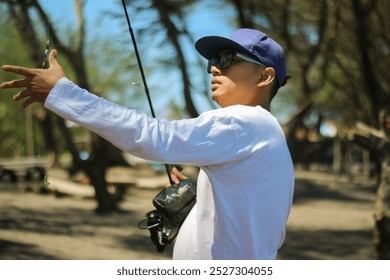 Mature man fishing on beach - Powered by Shutterstock