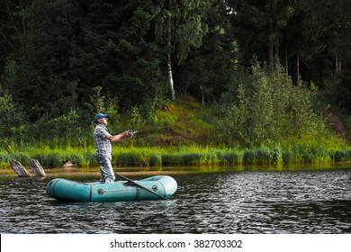 Mature Man Fishing On The Lake From Inflatable Boat