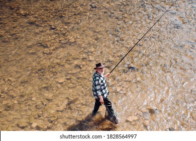 Mature Man Fishing On The Pond. Happy Fly Fishing. Angler Catching The Fish. Master Baiter. Catching And Fishing. Rural Getaway. Giving Your Hobby