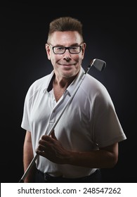 Mature Man Golfer Wearing A White Shirt And He Holds A Iron Golf Club On His Shoulder And He Looking At Camera - Studio Shot, Black Background