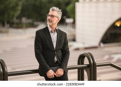 Mature Man With Gray Hair, And Glasses, Businessman Leaving Work