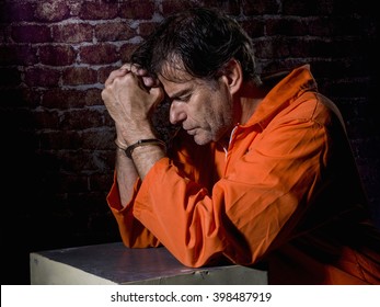 Mature Man, Handcuffed And Locked In Prison, With Gestures Of Repentance