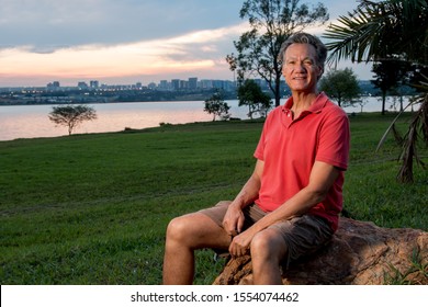 Mature Man Hanging Out At The Park Wearing Casual Clothes At Sundown