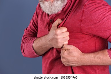 Mature man having heart attack, closeup