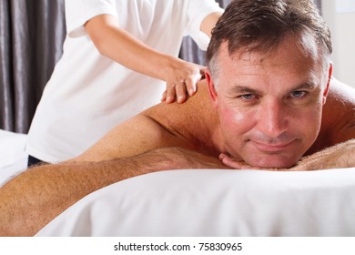 Mature Man Having Massage At Spa Salon