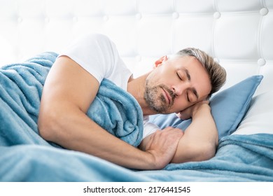 mature man having siesta in bed. early morning