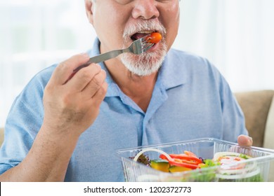 Mature Man With Healthy Food, Portrait Asian Senior Man Eating A Salad In House, Old Elderly Male Health Care Eat Vegetables And Useful Foods.