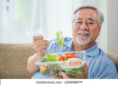 Mature Man With Healthy Food, Portrait Asian Senior Man Eating A Salad In House, Old Elderly Male Health Care Eat Vegetables And Useful Foods.