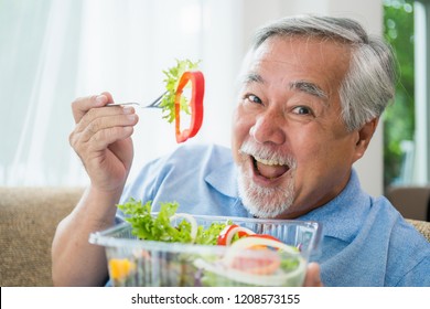 Mature Man With Healthy Food, Portrait Asian Senior Man Eating A Salad In House, Old Elderly Male Health Care Eat Vegetables And Useful Foods.