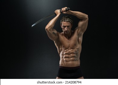 Mature Man Holding Sword Ready To Fight - Portrait Of A Handsome Muscular Ancient Warrior With A Sword