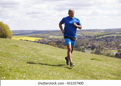 Mature Man Jogging In Countryside