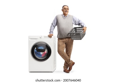 Mature Man Leaning On A Washing Machine And Holding An Empty Laundry Basket Isolated On White Background