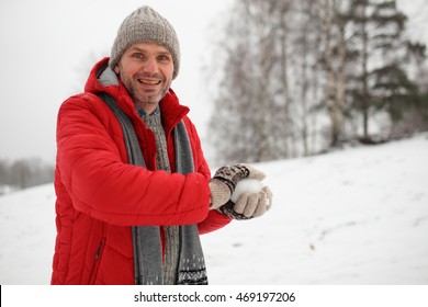 Mature Man Making Snowball During Snowball Fight