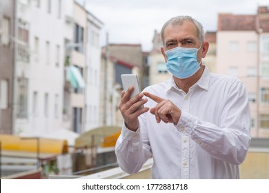 mature man with medical mask using mobile phone - Powered by Shutterstock