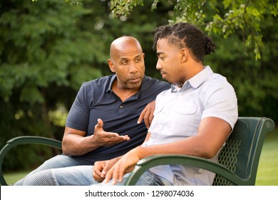 Mature Man Mentoring And Giving Advice To A Younger Man.