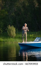 Mature Man On A Motor Boat. Fishing