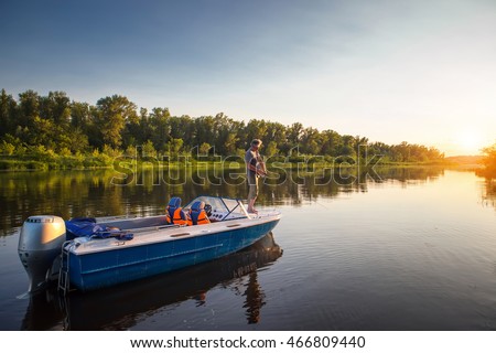 Mature man on a motor boat. Fishing.