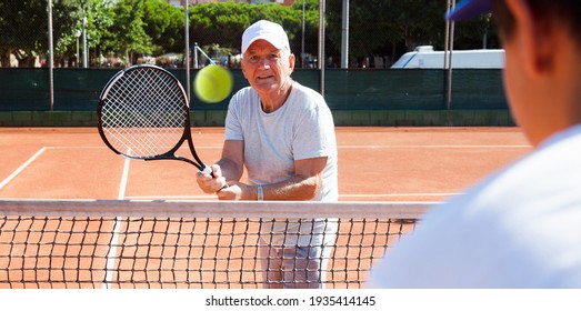 Mature Man Playing At Tennis Court