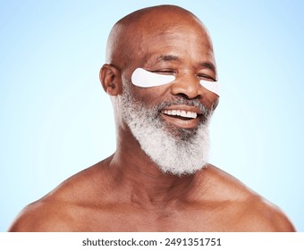 Mature man, portrait and skincare in studio with eye mask for cleaning, smooth and skin moisturizer. Balck person, beauty and dermatology on blue background with patch for wellness or hyaluronic acid - Powered by Shutterstock