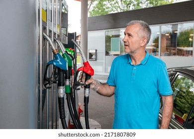 Mature Man Pouring Petrol Into Tank Of His Vehicle On Filling Station. Travel,transportation And Holiday