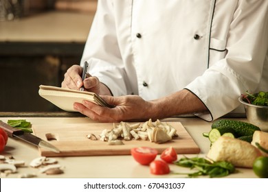  Mature man professional chef cooking meal indoors - Shutterstock ID 670431037