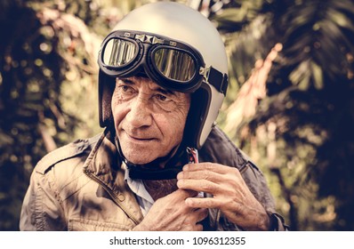 Mature Man Putting On A Helmet