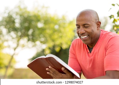 Mature man reading outside. - Powered by Shutterstock