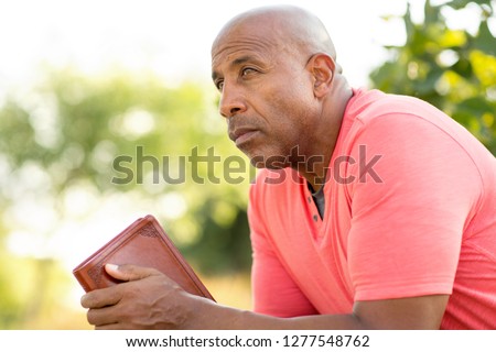 Mature man reading and thinking.